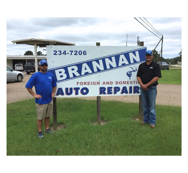 Brannan Auto & Glass employees posing with sign