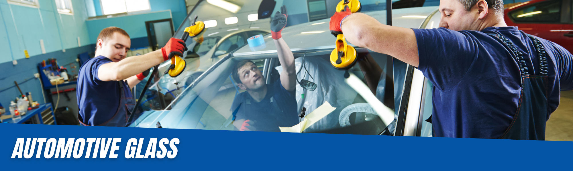 team installing a new windshield on a car